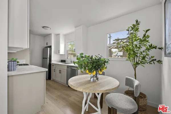 a kitchen with a table and chairs in it