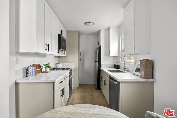a kitchen with a sink stove and refrigerator