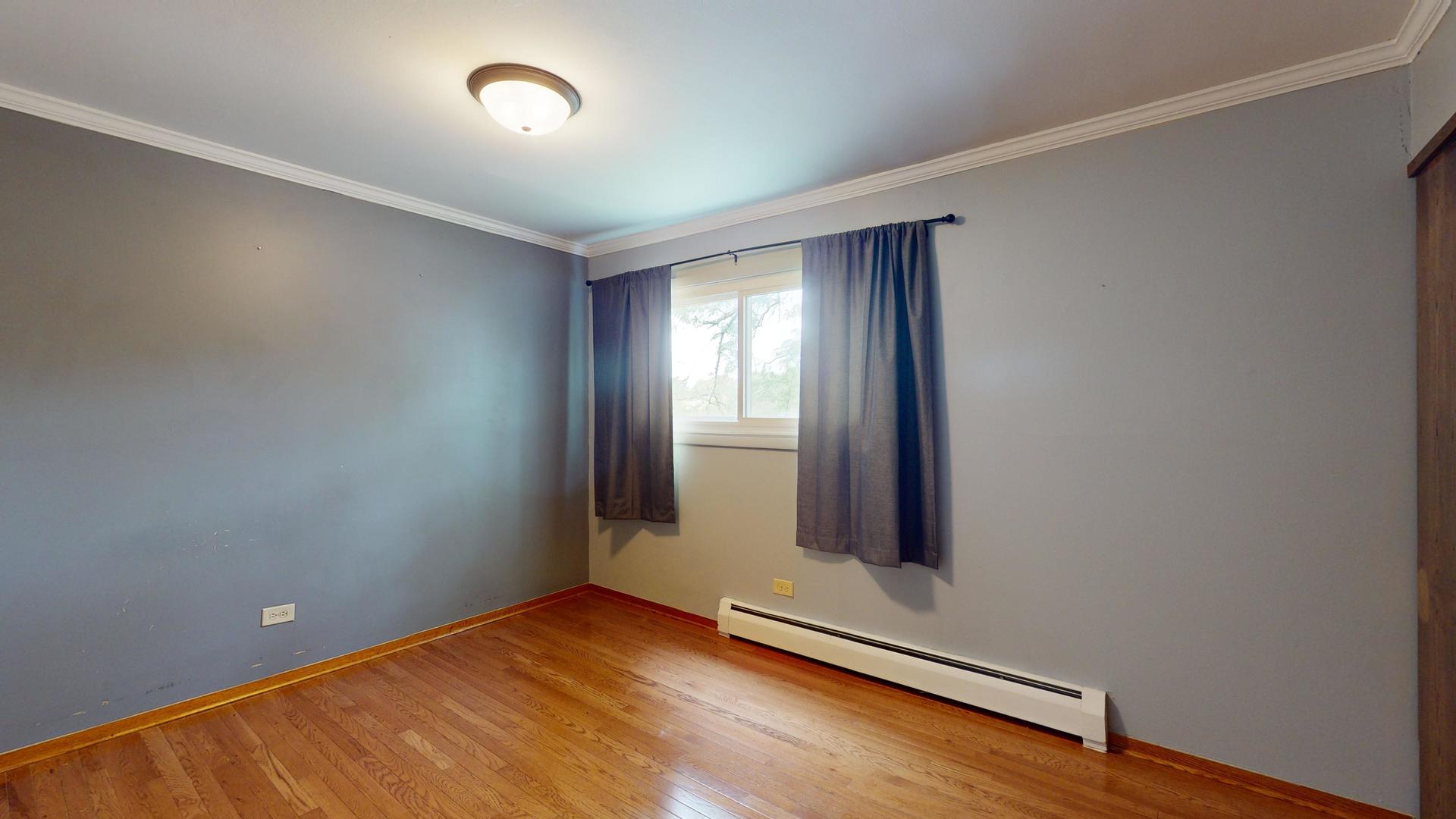 2302 West Algonquin Road, Unit 12 Rolling Meadows, IL 60008 - Photo 11 of 22 an empty room with windows
