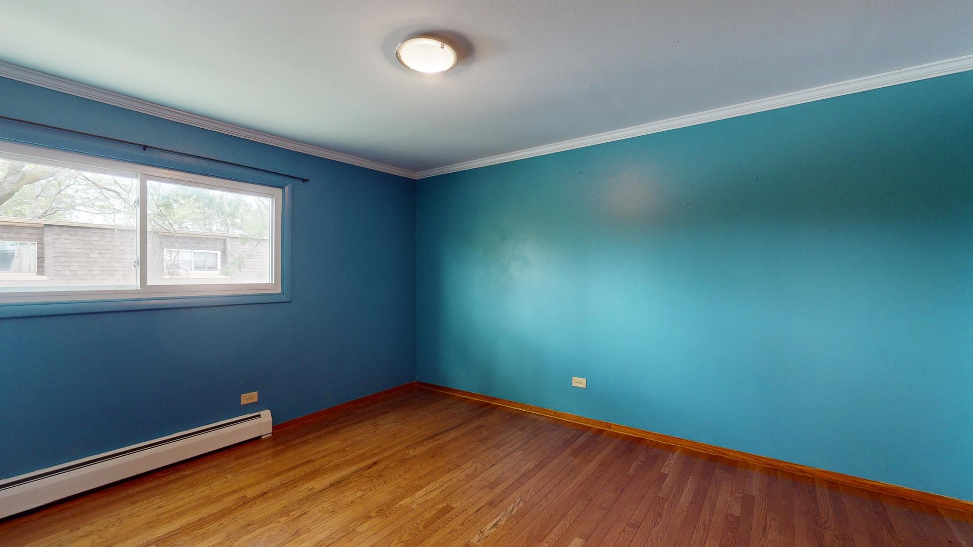 2302 West Algonquin Road, Unit 12 Rolling Meadows, IL 60008 - Photo 13 of 22 an empty room with a window