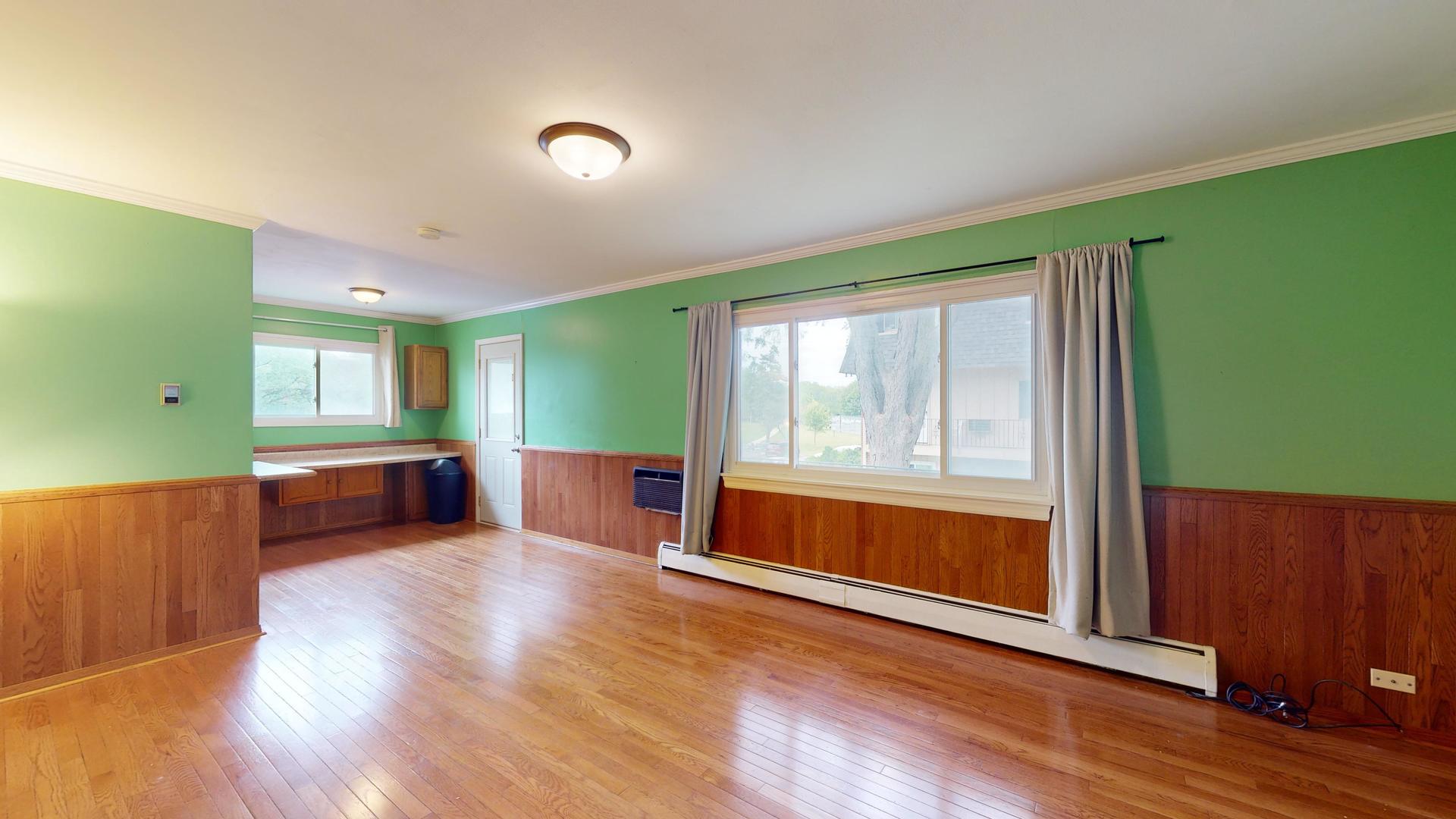 2302 West Algonquin Road, Unit 12 Rolling Meadows, IL 60008 - Photo 4 of 22 a living room with furniture and a large window