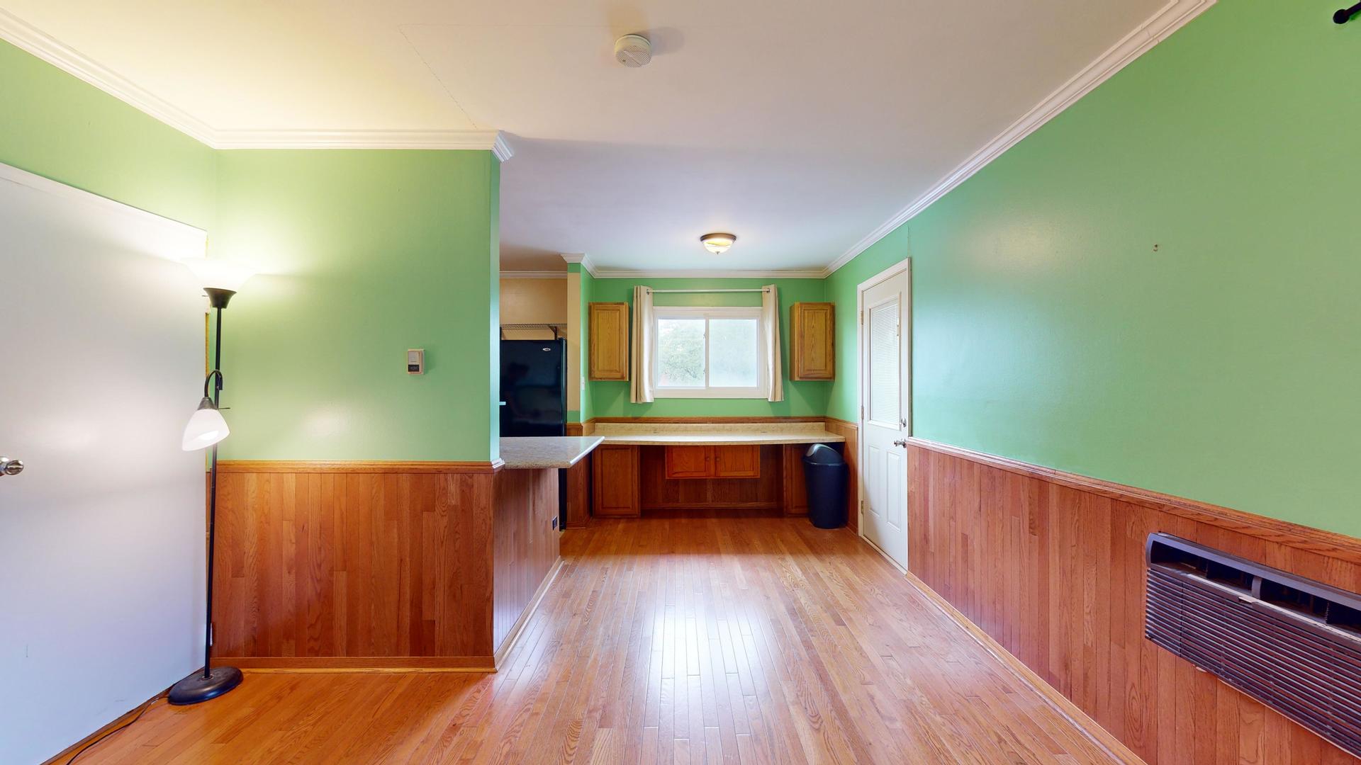 2302 West Algonquin Road, Unit 12 Rolling Meadows, IL 60008 - Photo 6 of 22 a room with window and wooden floor