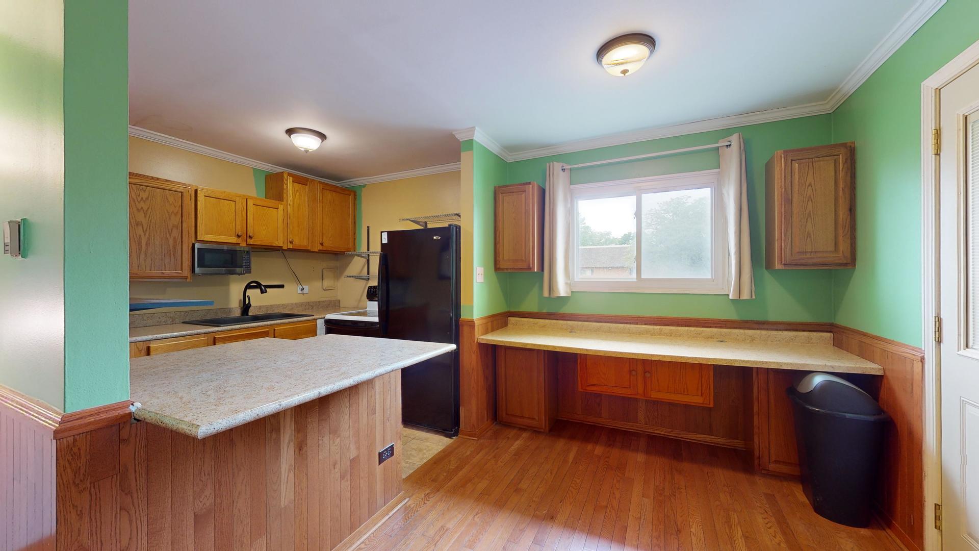 2302 West Algonquin Road, Unit 12 Rolling Meadows, IL 60008 - Photo 7 of 22 a kitchen with stainless steel appliances granite countertop a sink and a refrigerator