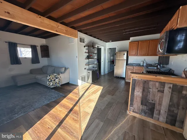 a bedroom with furniture and a flat screen tv