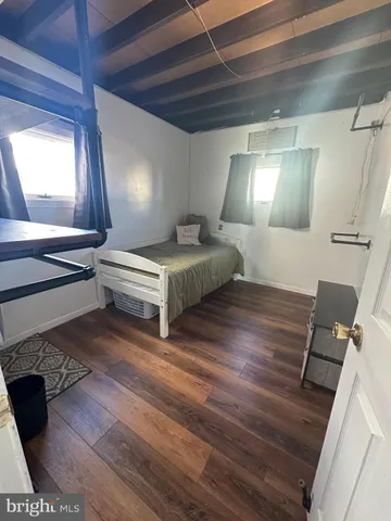 a spacious bedroom with a bed and a dresser in it