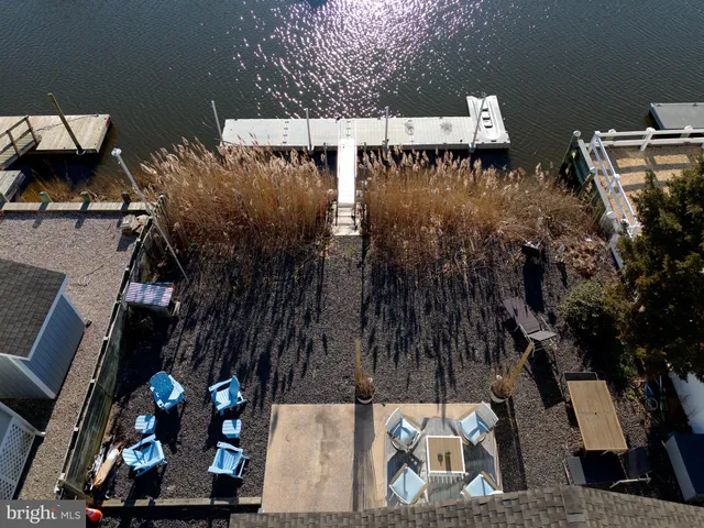 an aerial view of waterside residential building with parking