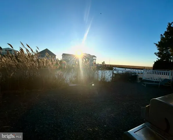 a view of a patio with table and chairs with wooden floor and fence