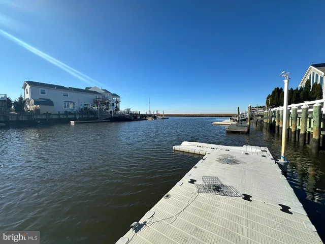 a roof deck with table and chairs