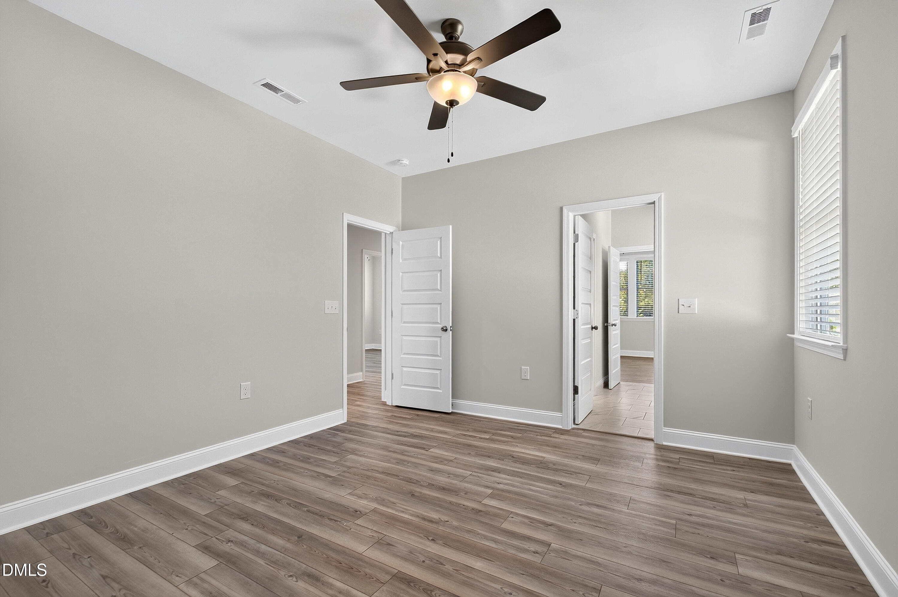 1300 Commons Ford Place Apex, NC 27539 - Photo 52 of 70 an empty room with wooden floor and ceiling fan