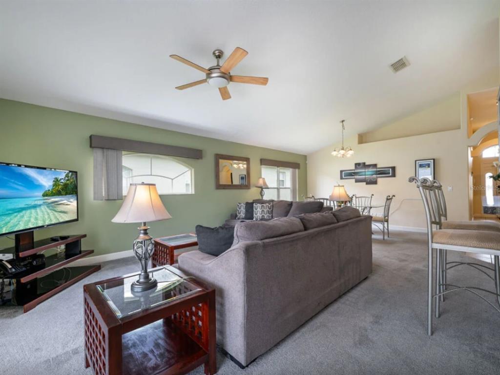 641 Old Bridge Circle Davenport, FL 33897 - Photo 15 of 28 a living room with furniture and a flat screen tv