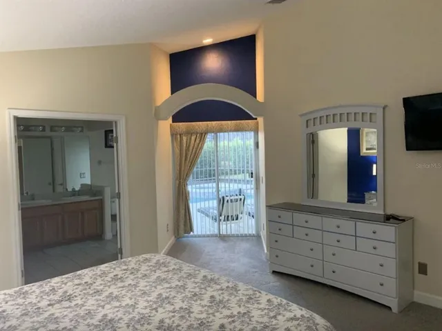 a bedroom with a bed and a dresser in it