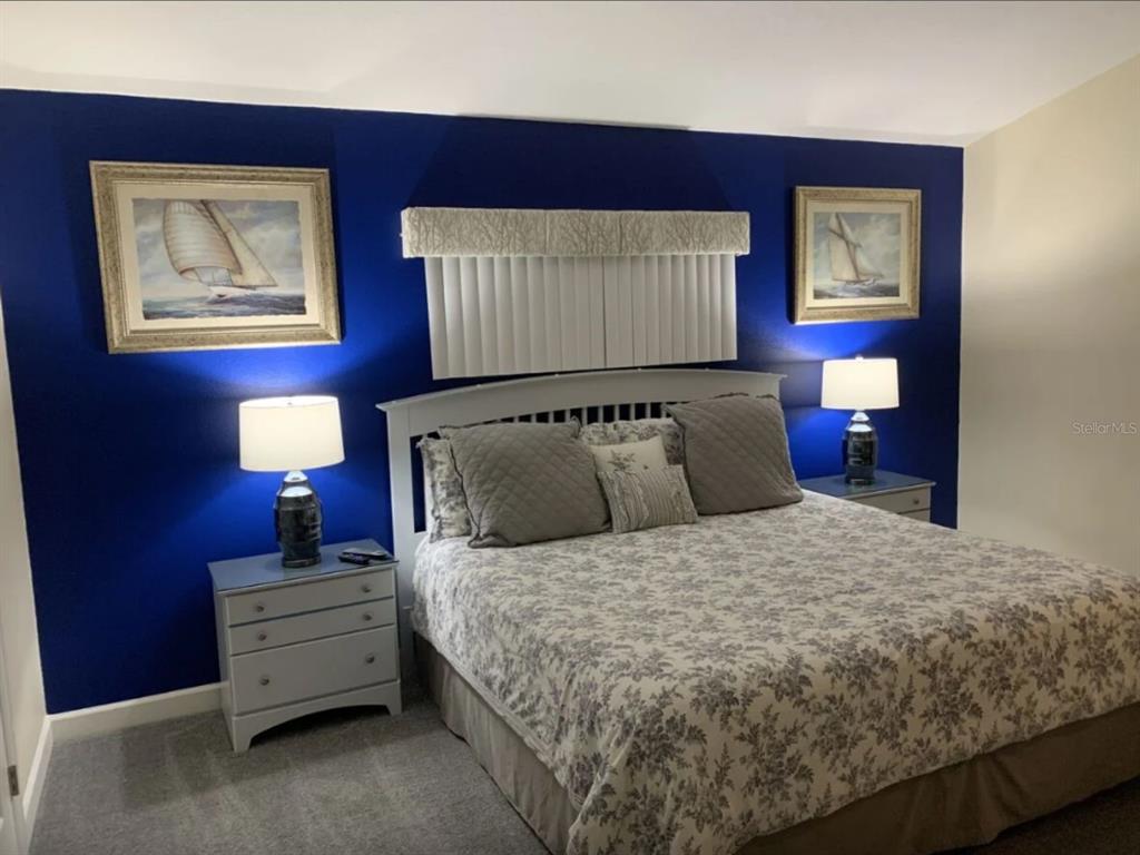 641 Old Bridge Circle Davenport, FL 33897 - Photo 17 of 28 a bedroom with a bed and a lamp on dresser