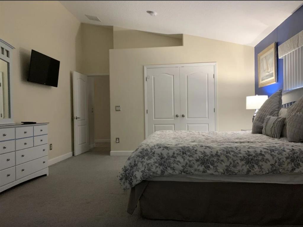 641 Old Bridge Circle Davenport, FL 33897 - Photo 18 of 28 a bedroom with a bed and a flat screen tv