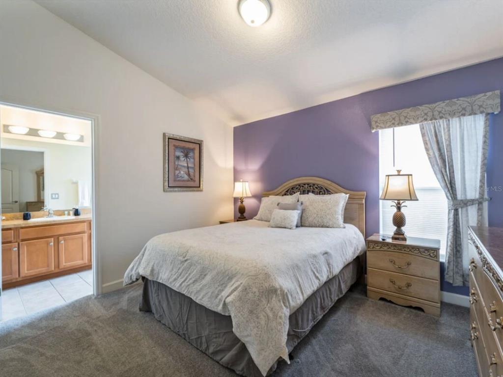 641 Old Bridge Circle Davenport, FL 33897 - Photo 20 of 28 a bedroom with a bed and a large window