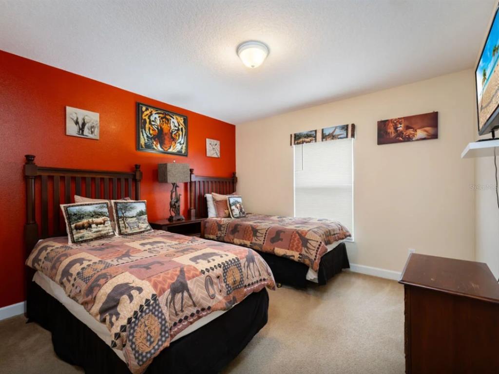 641 Old Bridge Circle Davenport, FL 33897 - Photo 22 of 28 a bedroom with two beds and a window