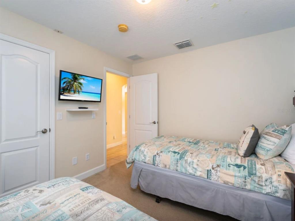 641 Old Bridge Circle Davenport, FL 33897 - Photo 25 of 28 a bedroom with a bed and wooden floor