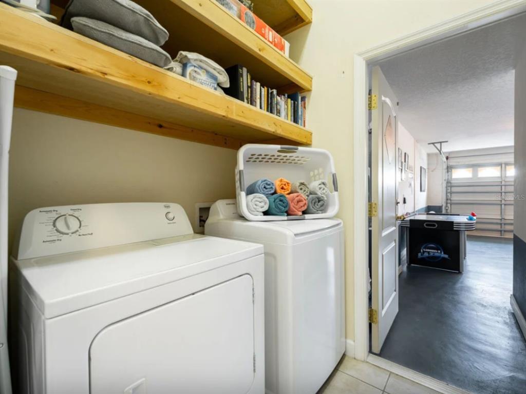 641 Old Bridge Circle Davenport, FL 33897 - Photo 26 of 28 a view of washer and dryer with kitchen in the background