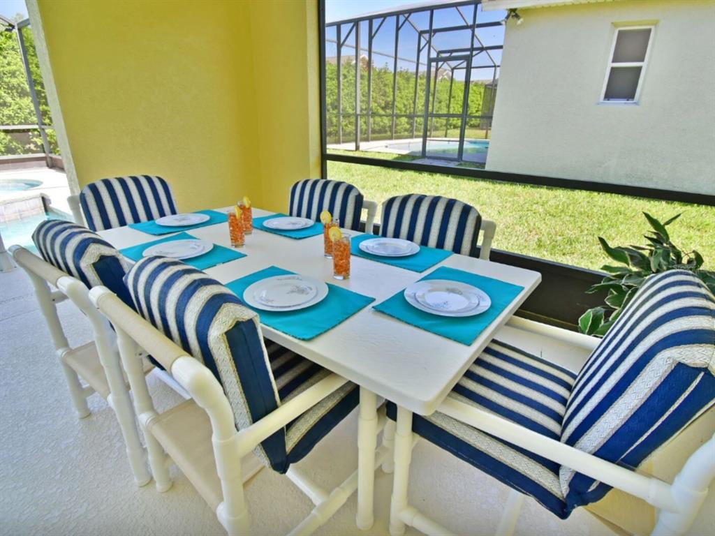 641 Old Bridge Circle Davenport, FL 33897 - Photo 6 of 28 a view of a dining room with furniture a chandelier and wooden floor