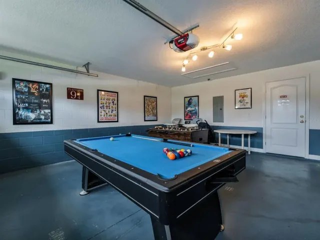 a room with pool table and flat screen tv
