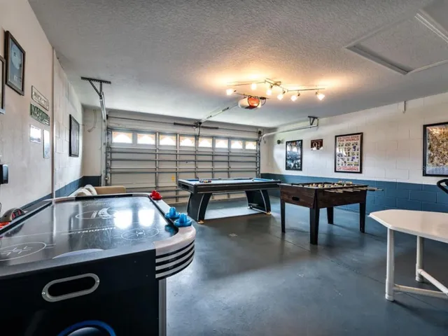 a kitchen with kitchen island a dining table chairs cabinets and stainless steel appliances