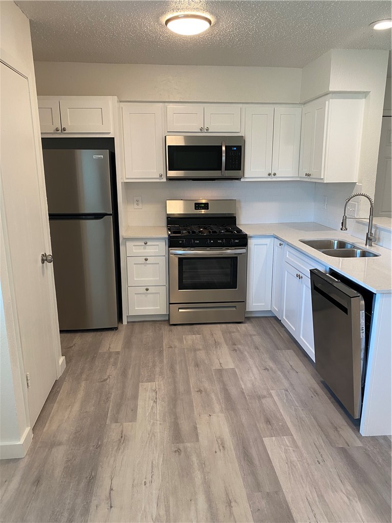 2305 Cedrick Cove, Unit D Austin, TX 78748 - Photo 9 of 39 Kitchen with stainless appliances (refrigerator, gas range, microwave & dishwasher)