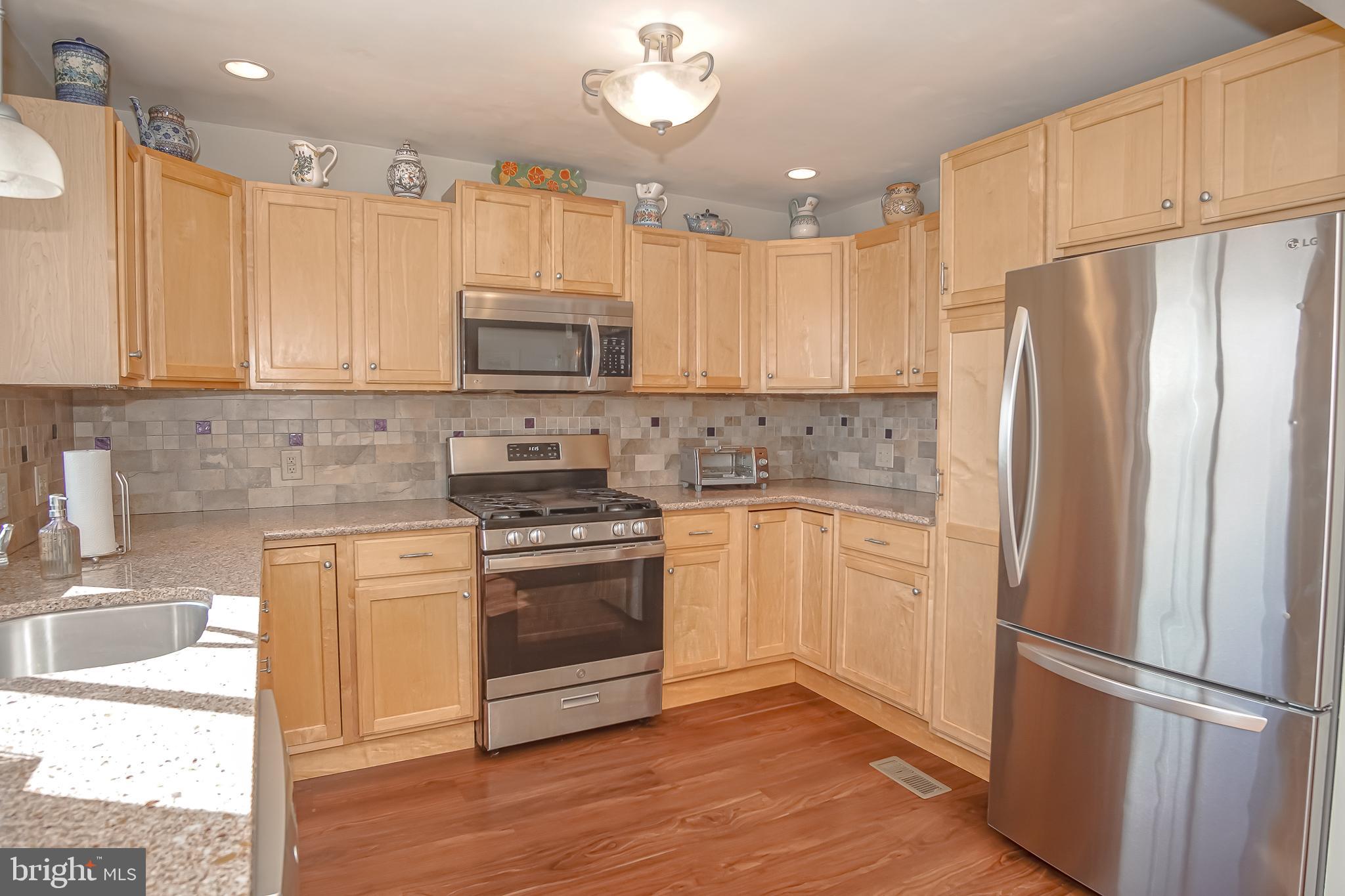 35 Walkill Road Tuckerton, NJ 08087 - Photo 16 of 42 a kitchen with stainless steel appliances granite countertop a refrigerator a sink a stove a microwave and island