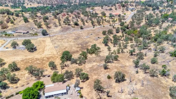 an aerial view of residential houses with yard
