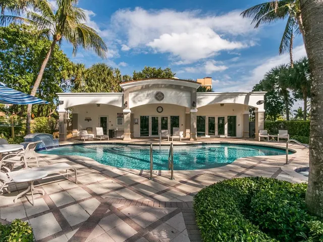 a view of house with outdoor space and swimming pool