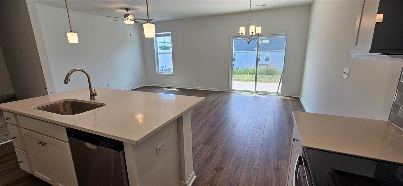 409 Belgrove Way Easley, SC 29640 - Photo 4 of 15 This bright kitchen with a breakfast bar seamlessly connects to the living space and outdoor patio.