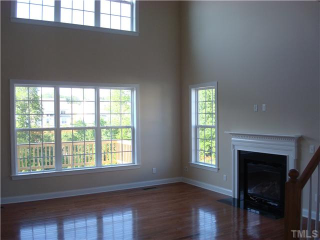 700 Ivyshaw Road Cary, NC 27519 - Photo 9 of 23 Family room with hardwood floors and lots of windows, electrical outlet and pipe chase for your plasma over the fireplace.