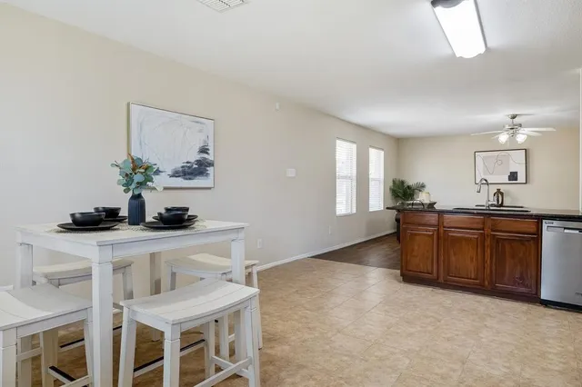a kitchen with granite countertop a sink cabinets and window