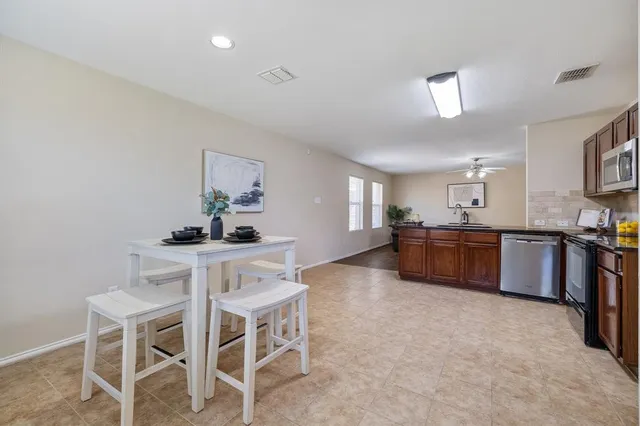 a kitchen with stainless steel appliances kitchen island granite countertop a sink and cabinets