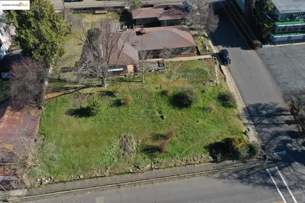 an aerial view of a house with a yard