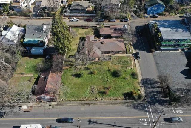 an aerial view of a house with a yard