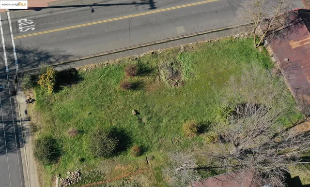 a view of a brick house next to a yard