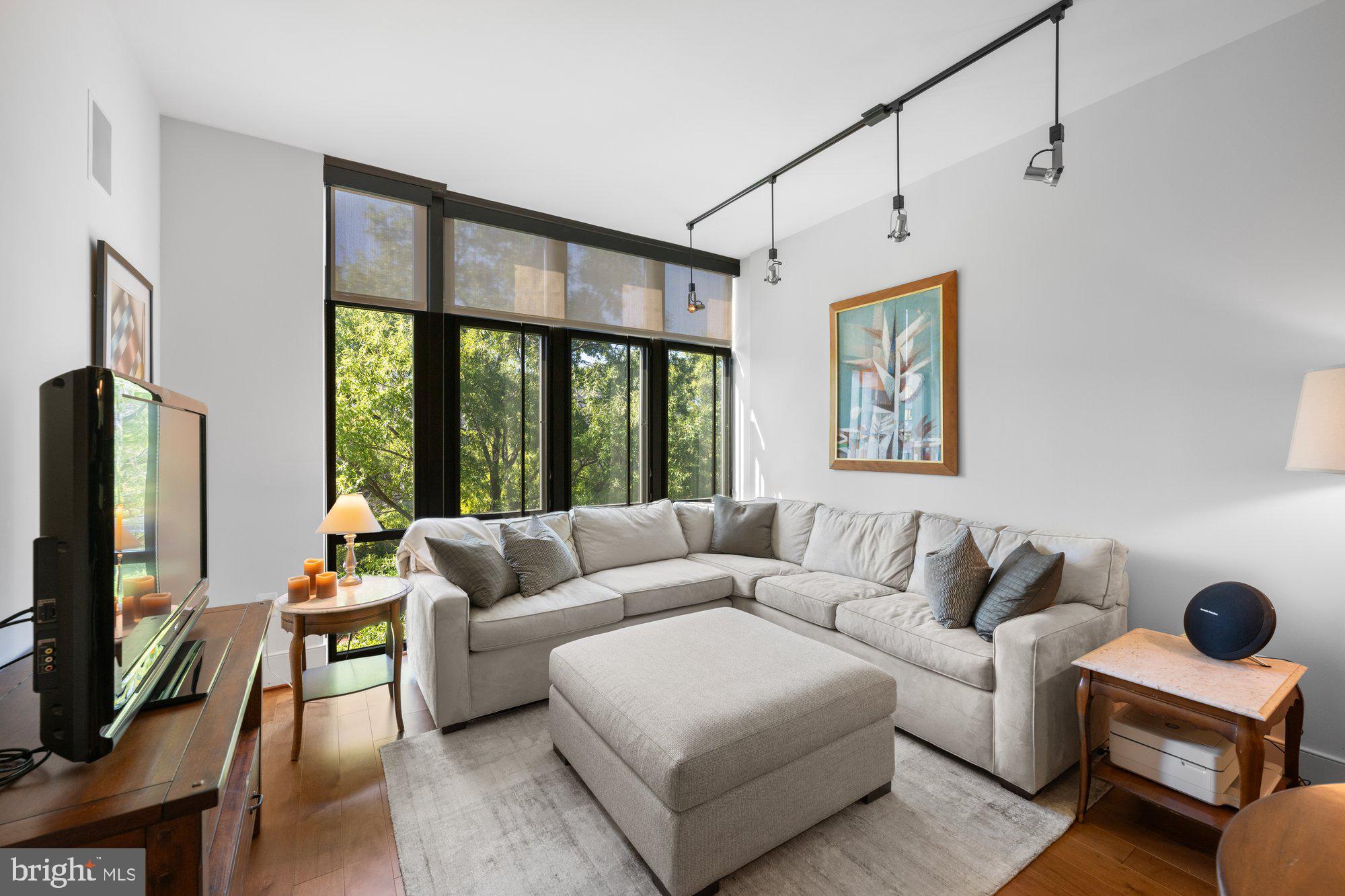 4301 Military Road Northwest, Unit 413 Washington, DC 20015 - Photo 10 of 24 Living room with floor to ceiling windows