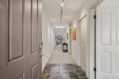 a view of a hallway with a furniture and a window