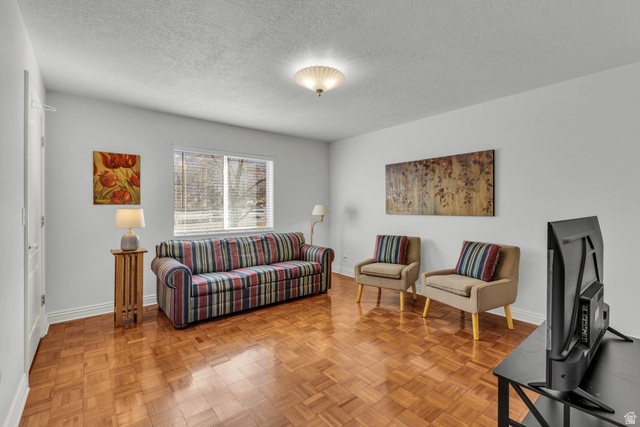 1060 West 2620th Street South Mapleton, UT 84664 - Photo 45 of 87 Living room featuring a textured ceiling and parquet flooring