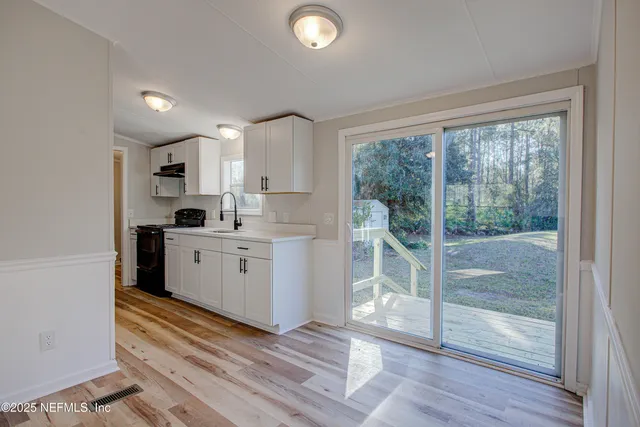 a kitchen with white cabinets and white appliances