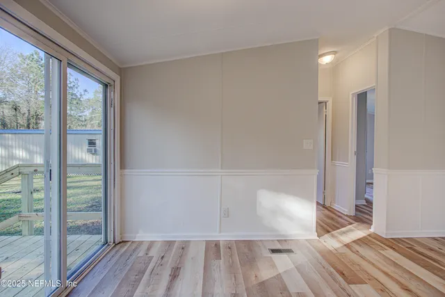 a view of a room with wooden floor and balcony