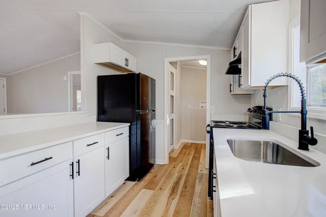 a kitchen with a sink and a refrigerator