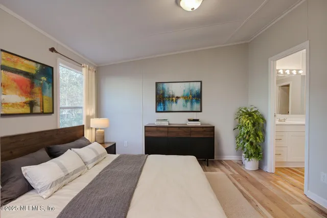 a bedroom with a bed and a potted plant
