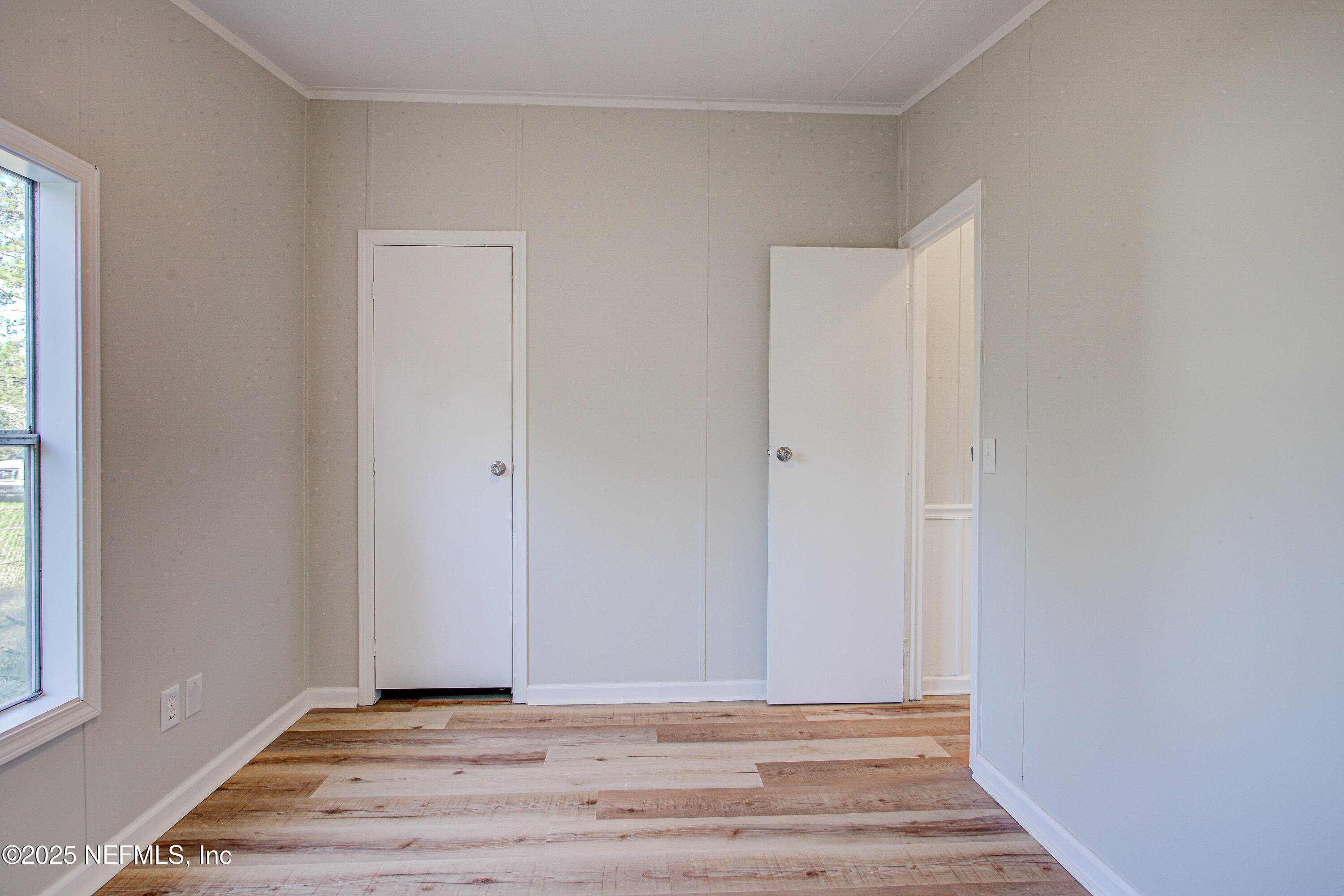 5175 Carter Spencer Road Middleburg, FL 32068 - Photo 25 of 41 a view of an empty room with wooden floor and a window
