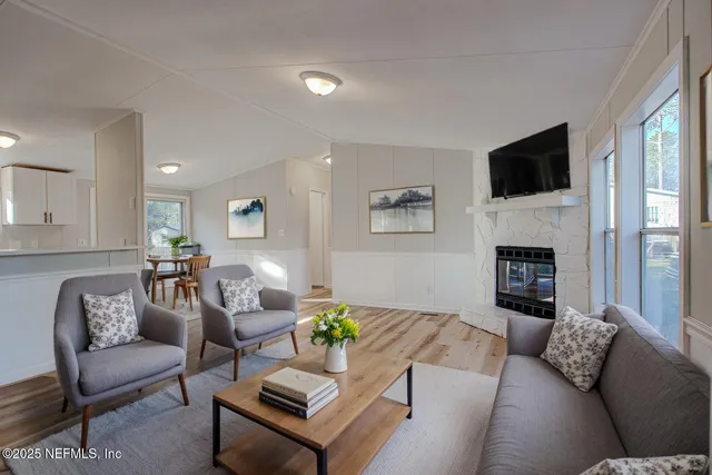 a living room with furniture fireplace and a flat screen tv