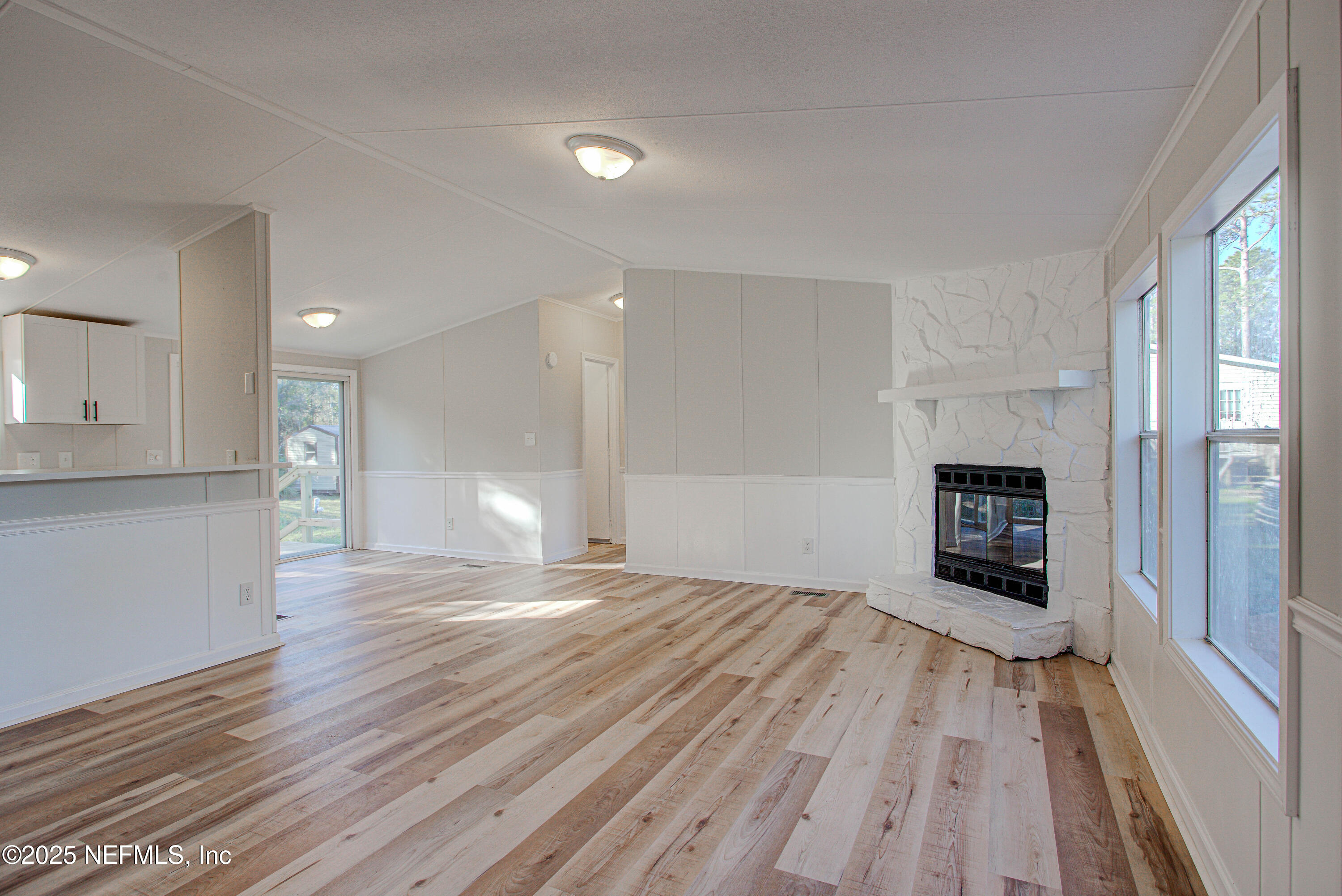 5175 Carter Spencer Road Middleburg, FL 32068 - Photo 6 of 41 a view of a big room with wooden floor and a kitchen