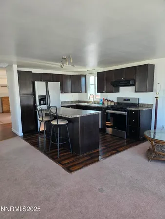 a kitchen with kitchen island a sink stove and microwave