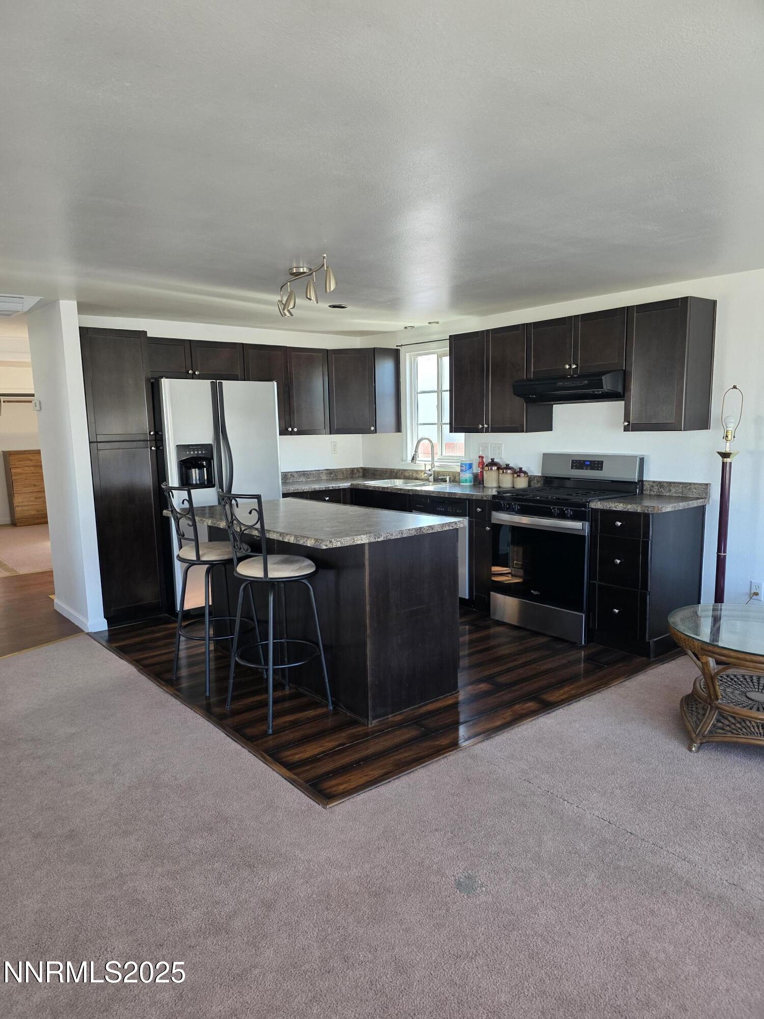 1110 4th Street Hawthorne, NV 89415 - Photo 11 of 27 a kitchen with kitchen island a sink stove and microwave