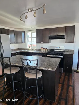 a kitchen with stainless steel appliances granite countertop a sink and a stove