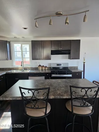 a kitchen with a dining table and chairs