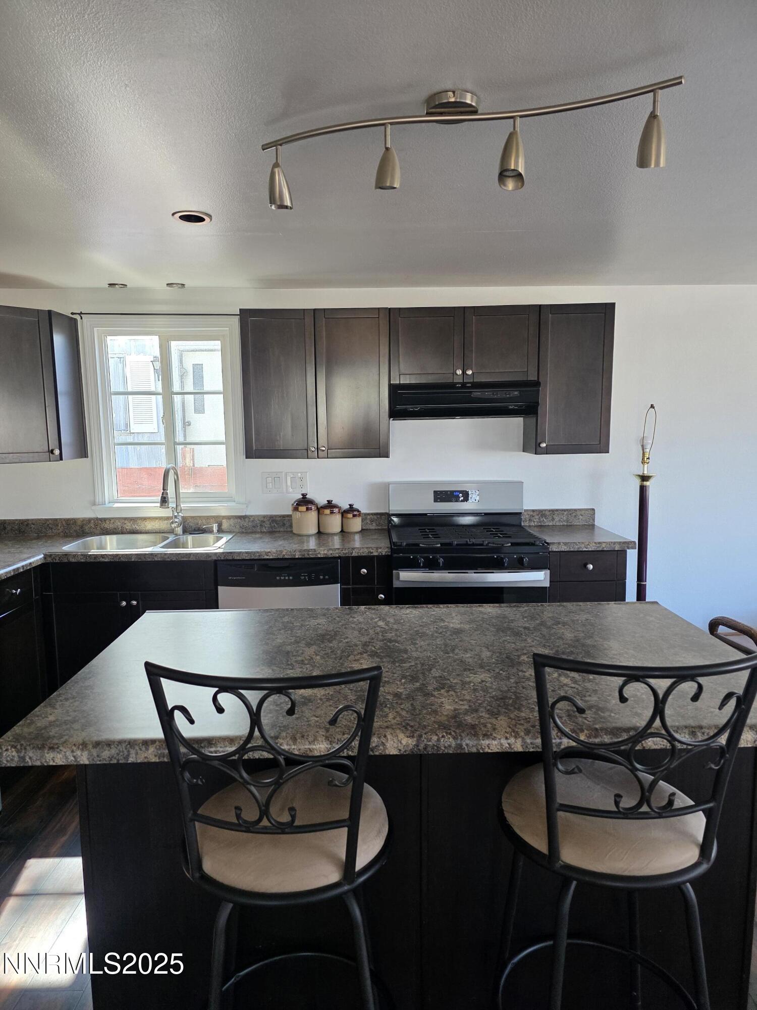 1110 4th Street Hawthorne, NV 89415 - Photo 13 of 27 a kitchen with a dining table and chairs